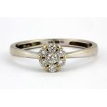 A 9ct white gold diamond set cluster ring, (O.5).