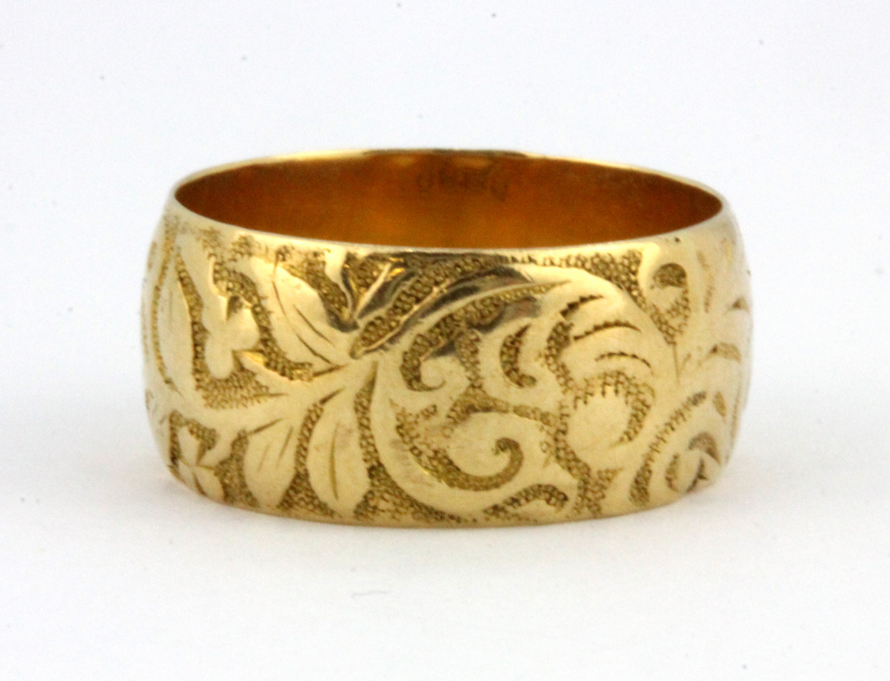 An 18ct yellow gold patterned ring, (L), W. 6.0g. - Image 2 of 2