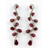 A pair of 925 silver drop earrings set with pear cut rubies and white stone, L. 5.2cm.