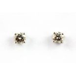 A pair of 18ct white gold diamond solitaire earrings, approx. 0.50ct overall, dia. 0.4cm.