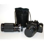 A Pentax single lens reflex camera with a TAKUMAR-A zoom lens and a Mitakon zoom lens.