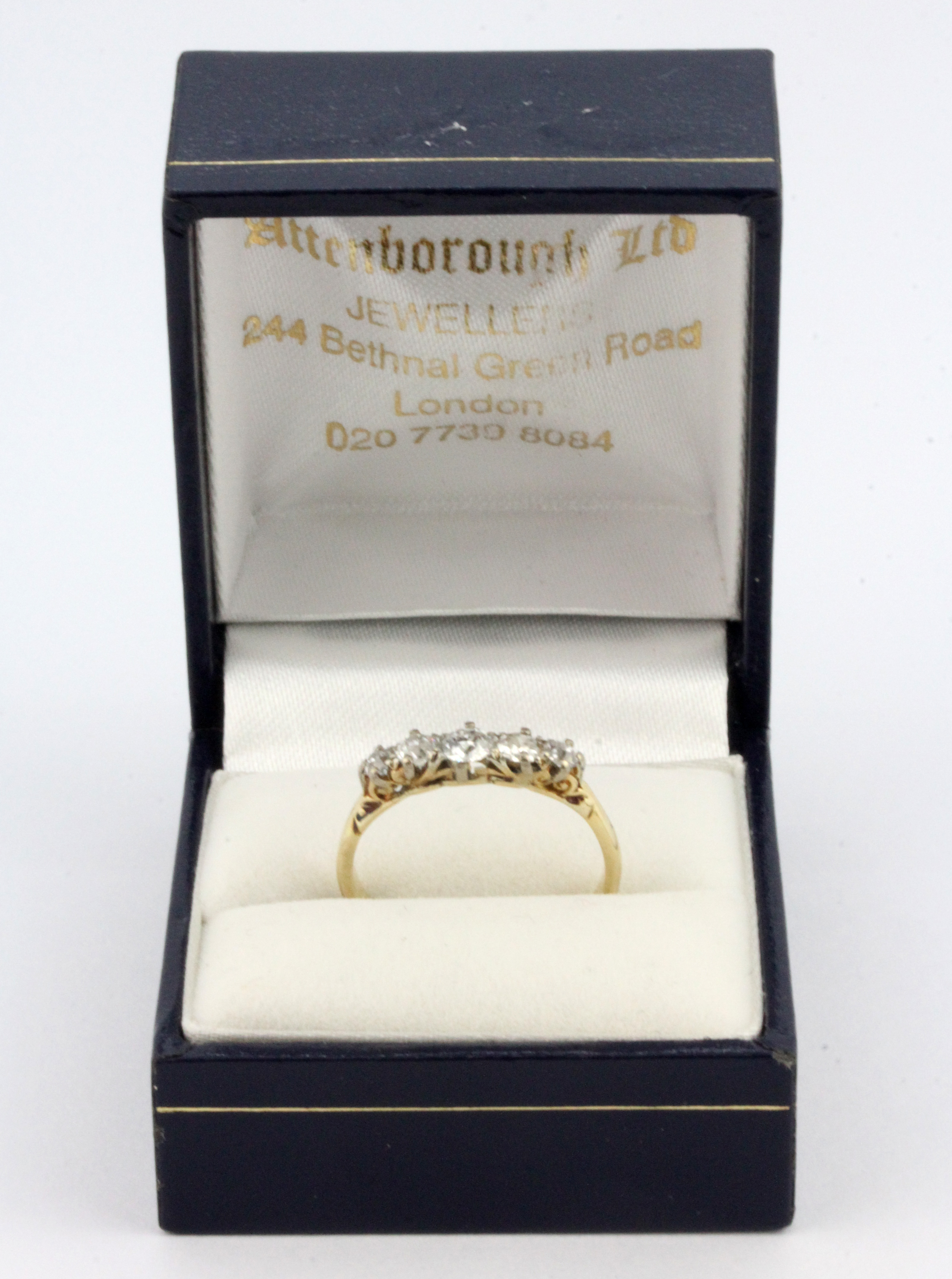 A boxed 18ct yellow gold (worn stamp 18ct) graduated brilliant cut diamond set ring, (P.5). - Image 3 of 3