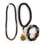 Three strands of Tibetan wooden prayer beads.