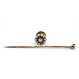 A boxed antique rose metal (tested 18ct gold) stick pin set with a diamond cluster, removable to