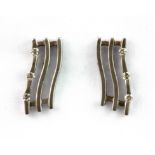 A pair of 18ct white gold diamond set wave shaped earrings, L. 1.8cm.