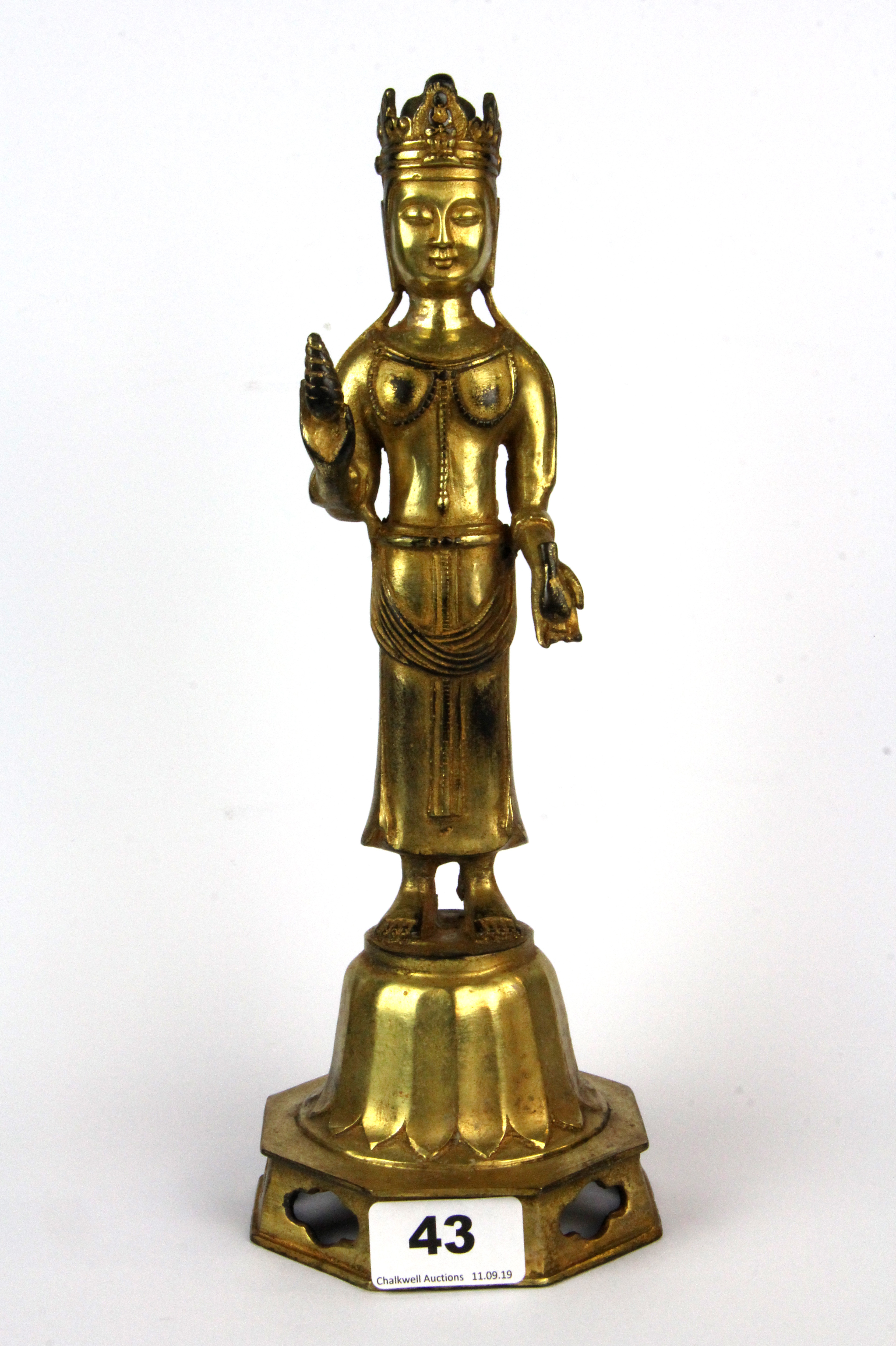 A Tibetan gilt bronze figure of a standing Buddha, H. 30cm.