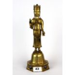 A Tibetan gilt bronze figure of a standing Buddha, H. 30cm.