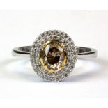 An 18ct white gold (stamped 750 cluster ring set with an oval cut fancy light brown diamond