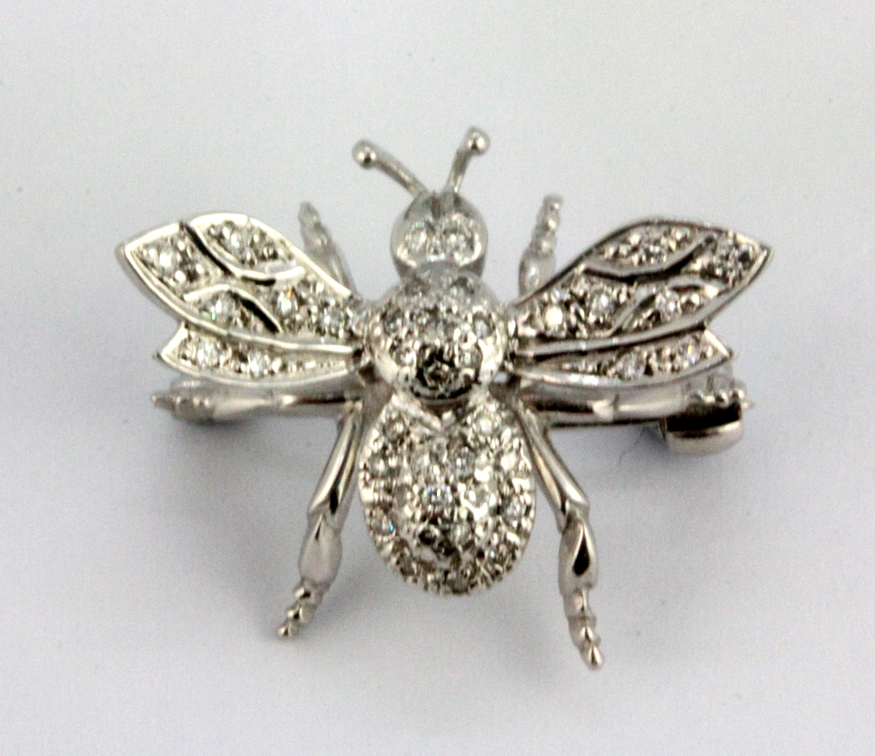 An 18ct white gold diamond set insect shaped brooch / pendant, L. 2.5cm.