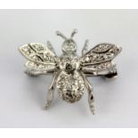 An 18ct white gold diamond set insect shaped brooch / pendant, L. 2.5cm.