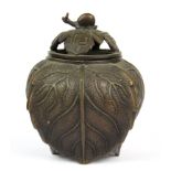 A 1920's Chinese bronze leaf shaped censer topped with a snail, H. 15cm.