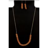 A 925 silver necklace set with faceted cornelian beads with matching pair of earrings.
