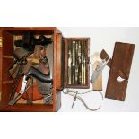 A mahogany box of mixed tools and drawing instruments.