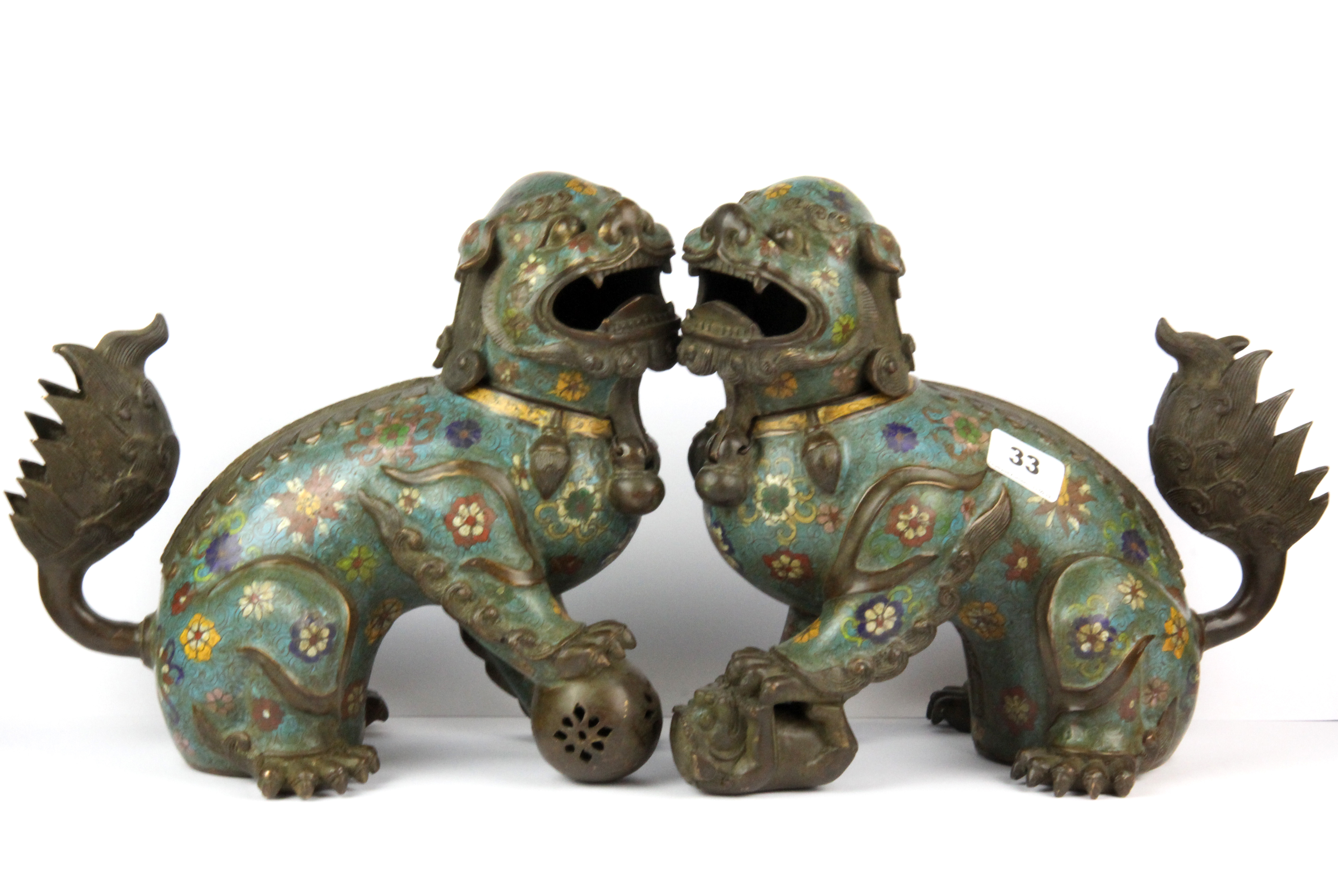 A pair of Chinese cloisonne enamel on bronze lion dog figures, H. 27cm.