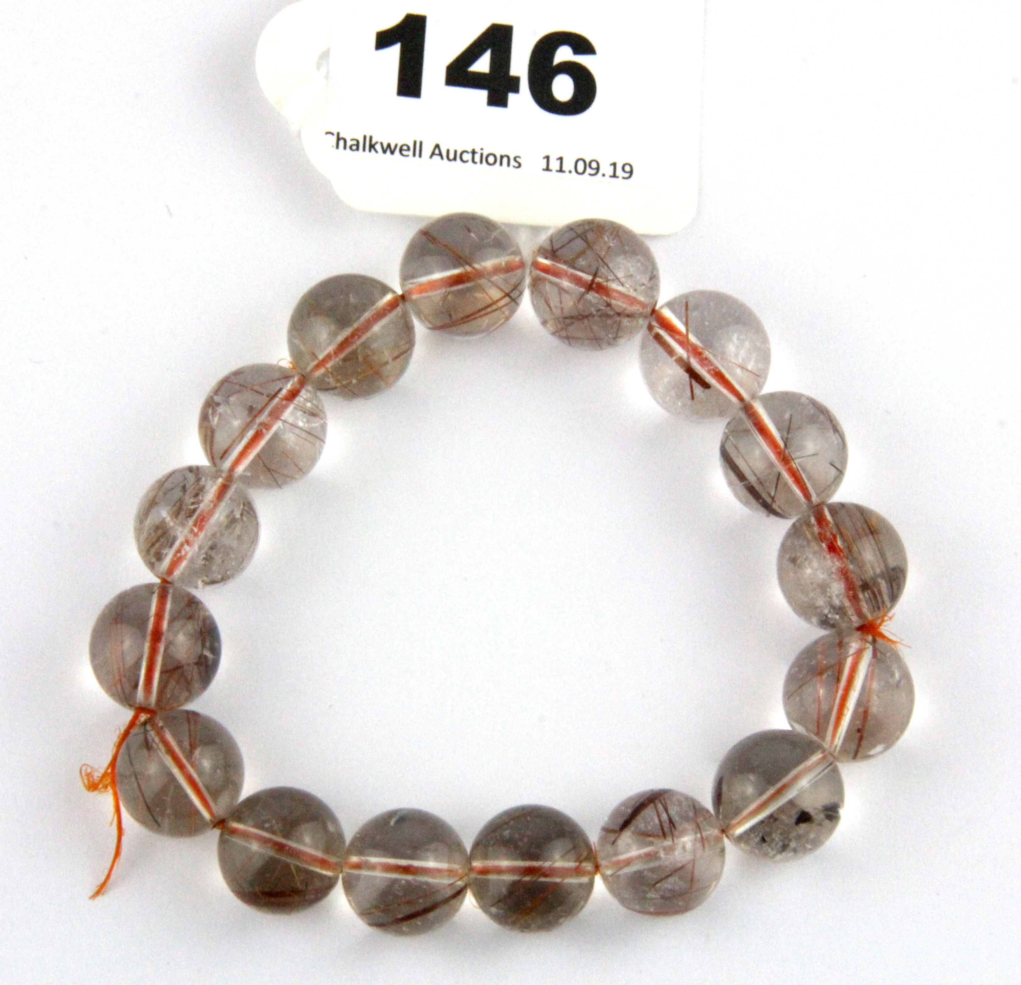 A bracelet strand of rutile quartz beads.