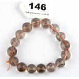 A bracelet strand of rutile quartz beads.