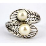 A white metal (tested gold plated silver) pearl set ring, (S.5).