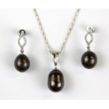 A pair of large black cultured pearls on silver drop earrings with a large black pearl silver