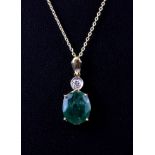 A yellow metal (tested 14ct gold) emerald and diamond set pendant on an 18ct gold chain.