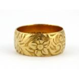 An 18ct yellow gold patterned ring, (L), W. 6.0g.