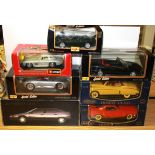 Seven large scale Burago, Maisto and other diecast model vehicles.