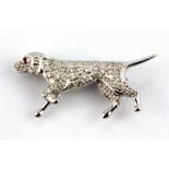 An 18ct white gold diamond and ruby set dog shaped brooch, L. 3cm.
