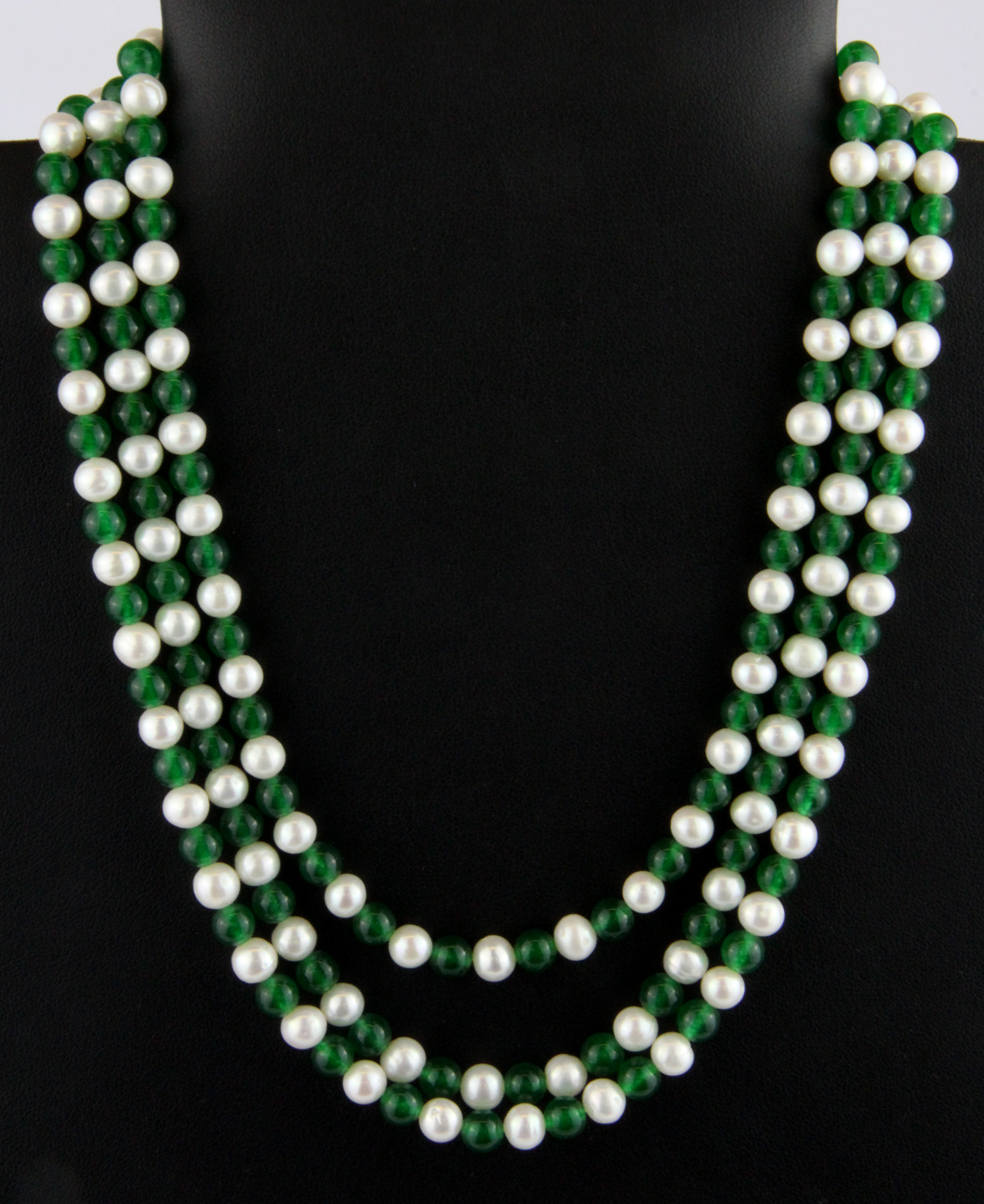A three row jade and cultured pearl necklace on a white metal clasp.
