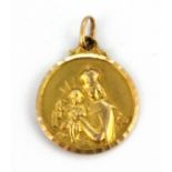 A yellow metal (tested minimum 9ct gold) religious pendant, L. 3cm, W. 3.7g.