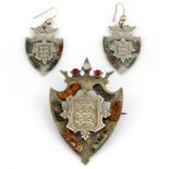 A hallmarked silver stone set brooch and matching pair of earrings, decorated with the Royal Coat of