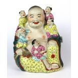 A mid 20th century Chinese porcelain figure of the happy Buddha with five children, H. 21cm.