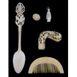 A 19th Century Chinese carved ivory parasol handle and four further ivory and bone items.