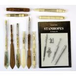 A group of carved bone and wood dip pen, paper knife and other stanhopes, together with a book on