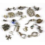 A bag of mixed silver charms and pendants.