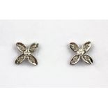 A pair of 9ct diamond set flower shaped stud earrings, L. 0.6cm.