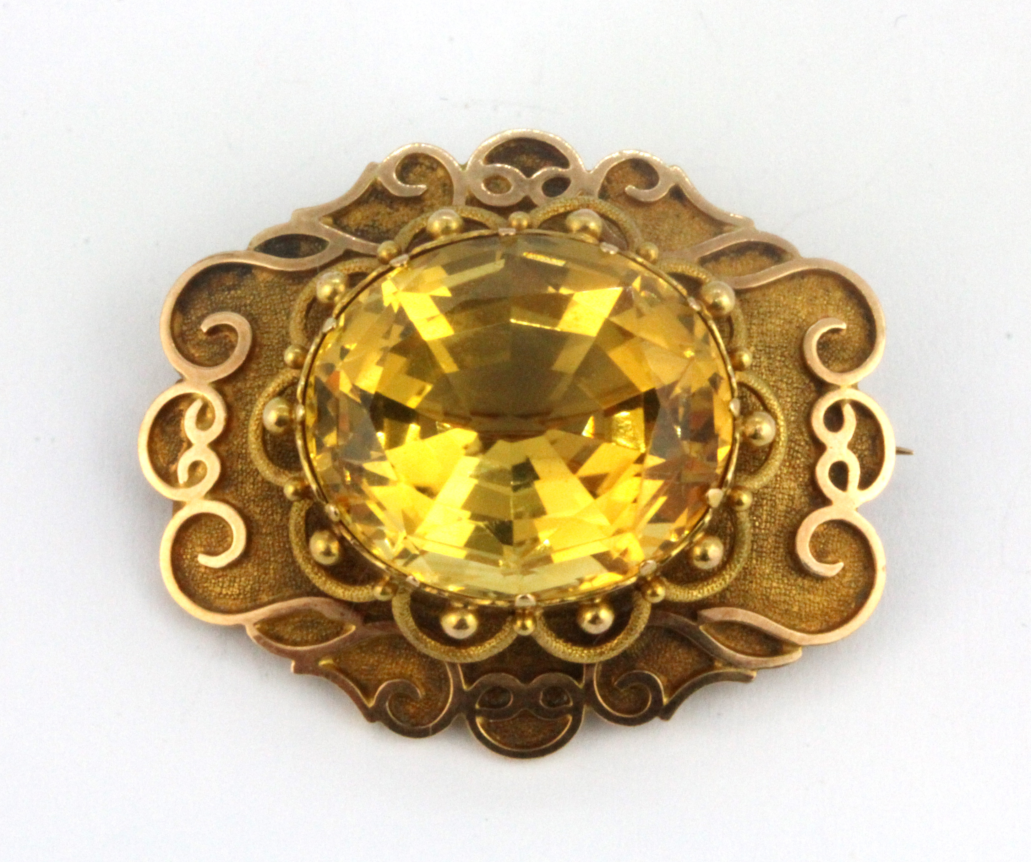 A yellow metal (tested high carat gold) brooch set with a large citrine, 3.3 x 2.8cm.