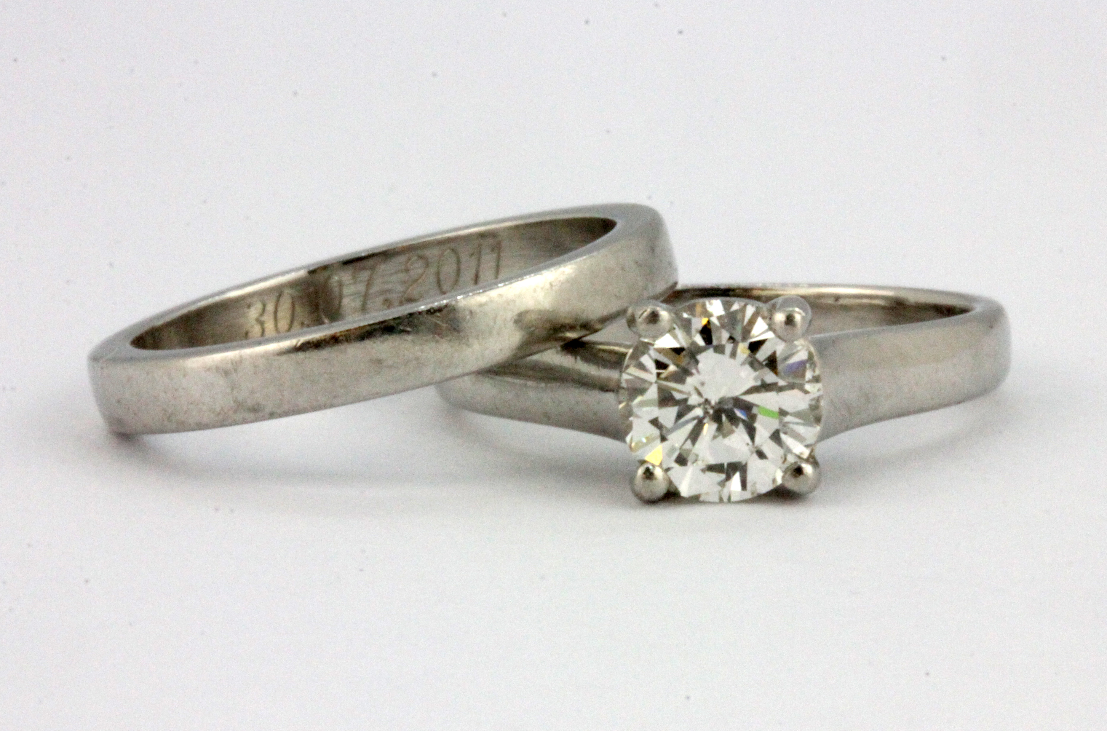 A 950 platinum brilliant cut diamond solitaire ring and matching wedding ring, with valuation for