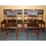 A set of six French carved oak dining chairs with Art Nouveau embossed leather upholstery.