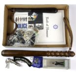 Two police truncheons and a collection of police related badges, whistles, etc.