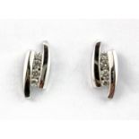 A pair of 18ct white gold diamond set earrings, L. 1.2cm.