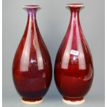 A pair of large 20th century Chinese Sang de boeuf glazed ceramic vases, H. 52cm.