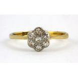 An 18ct yellow gold and platinum diamond set daisy cluster ring, (N).