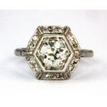 A white metal (tested 18ct gold) ring set with a centre brilliant cut diamond, surrounded by