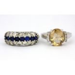 A 925 silver citrine and white stone set ring together with a further white metal stone set ring, (O