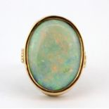 A yellow metal (tested minimum 9ct gold) ring set with a large opal doublet, (P).