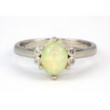 A 925 silver ring set with a cabochon cut opal and white stones, (P).