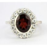 A 925 silver garnet and white topaz set cluster ring, (N).