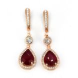 A pair of 925 silver rose gold gilt drop earrings set with a pear cut ruby and white stones, L.