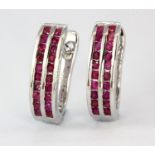 A pair of 925 silver earrings set with two rows of round cut rubies, L. 1.7cm.