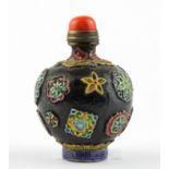 A Chinese relief decorated porcelain snuff bottle with coral stopper, H. 8cm.