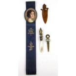 A 19th Century bronze and mother of pearl Napoleon bookmark, together with a carved wooden